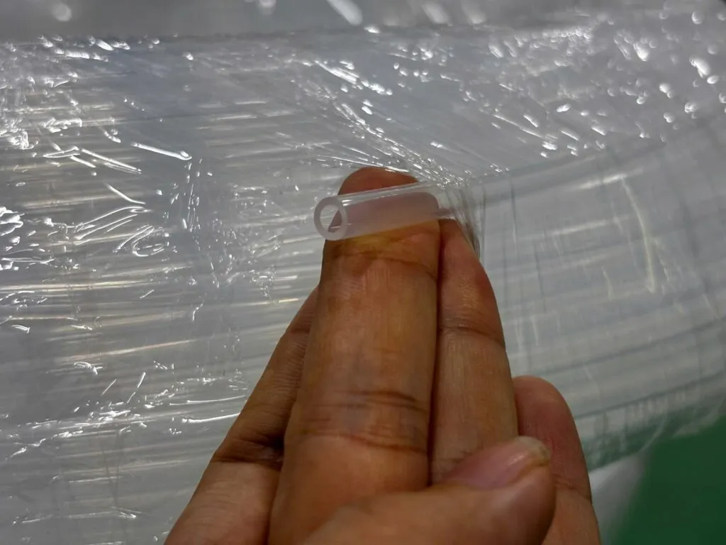Đầu ống PFA trong cầm trên tay cạnh cuộn